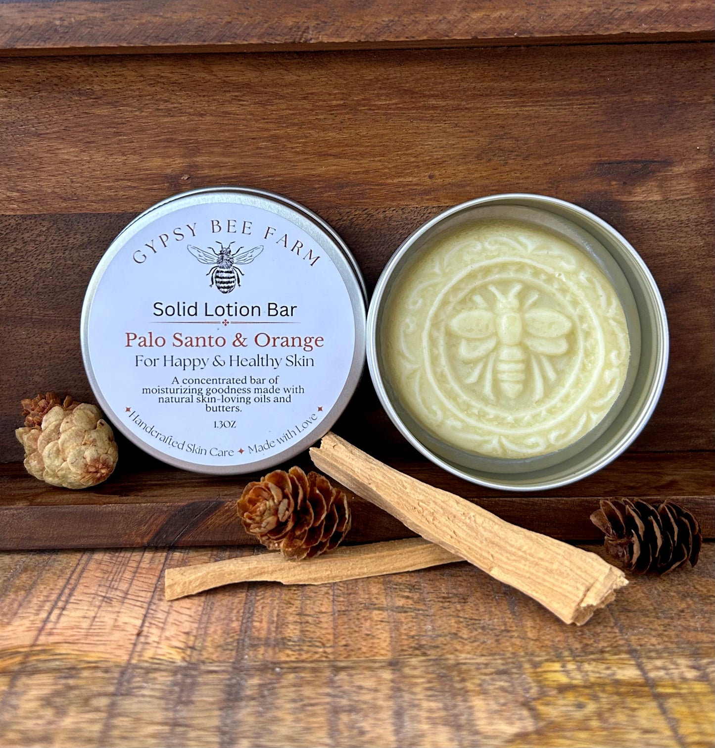 Solid lotion bar from Gypsy Bee Farm on a wooden surface with natural elements.