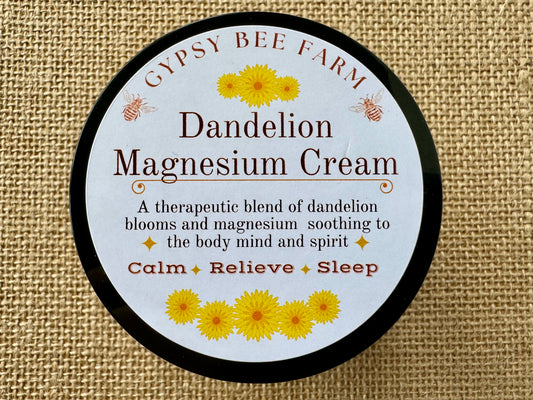 Gypsy Bee Farm dandelion magnesium cream container on a textured fabric background