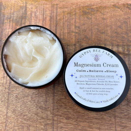 Gypsy Bee Farm magnesium cream in a black container on a wooden surface