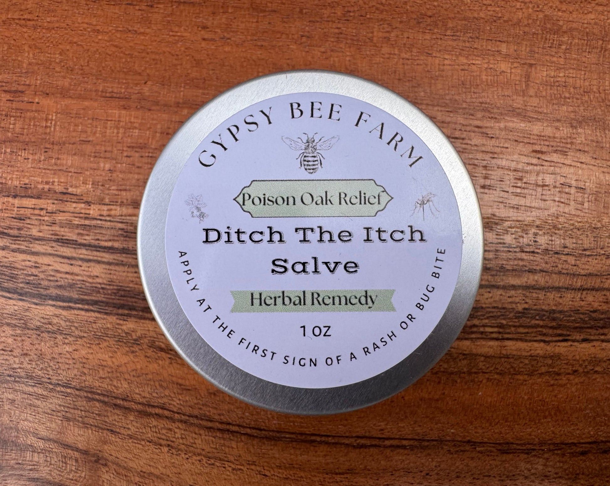 Gypsy Bee Farm Ditch The Itch Salve container on a wooden surface