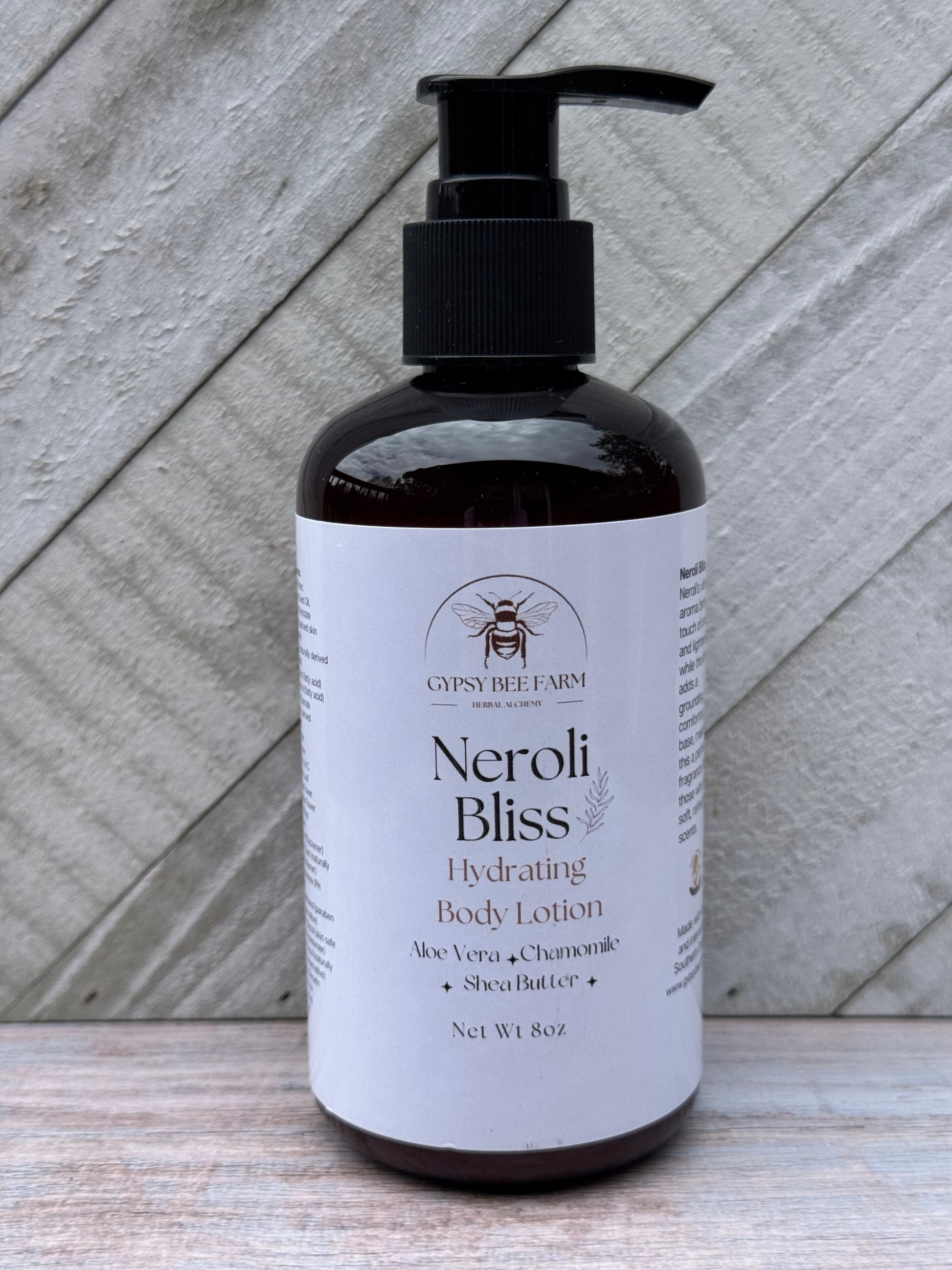 Neroli Bliss body lotion bottle on a wooden surface