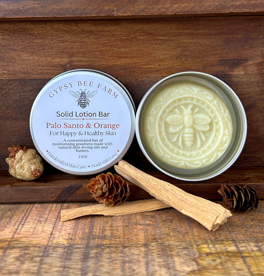 Solid lotion bar from Gypsy Bee Farm on a wooden surface with natural elements.