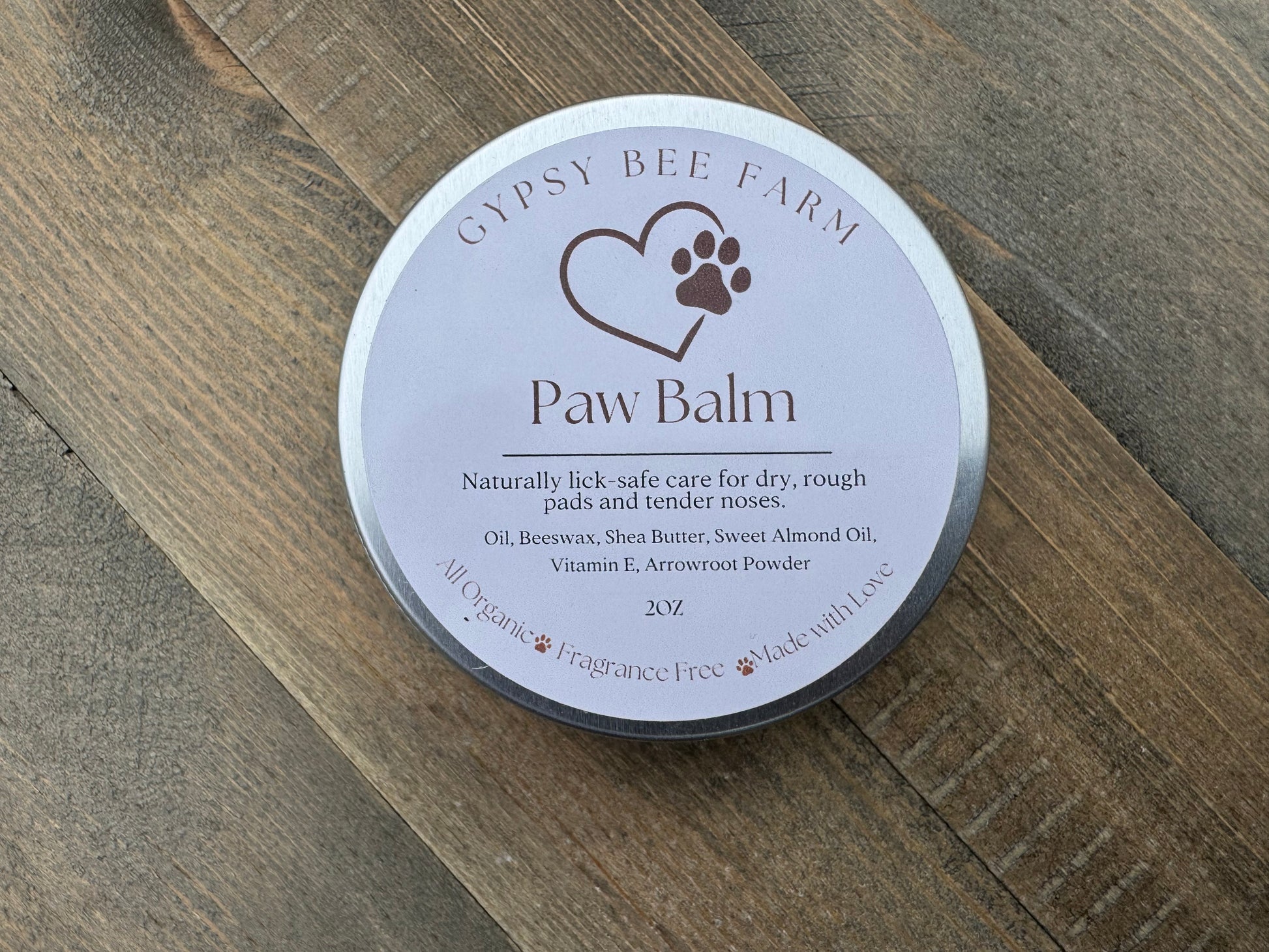 Gypsy Bee Farm Paw Balm container on a wooden surface