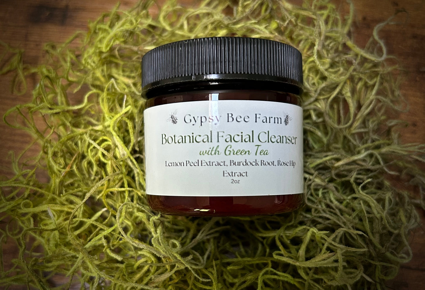 Jar of Gypsy Bee Farm Botanical Facial Cleanser with Green Tea on a textured surface
