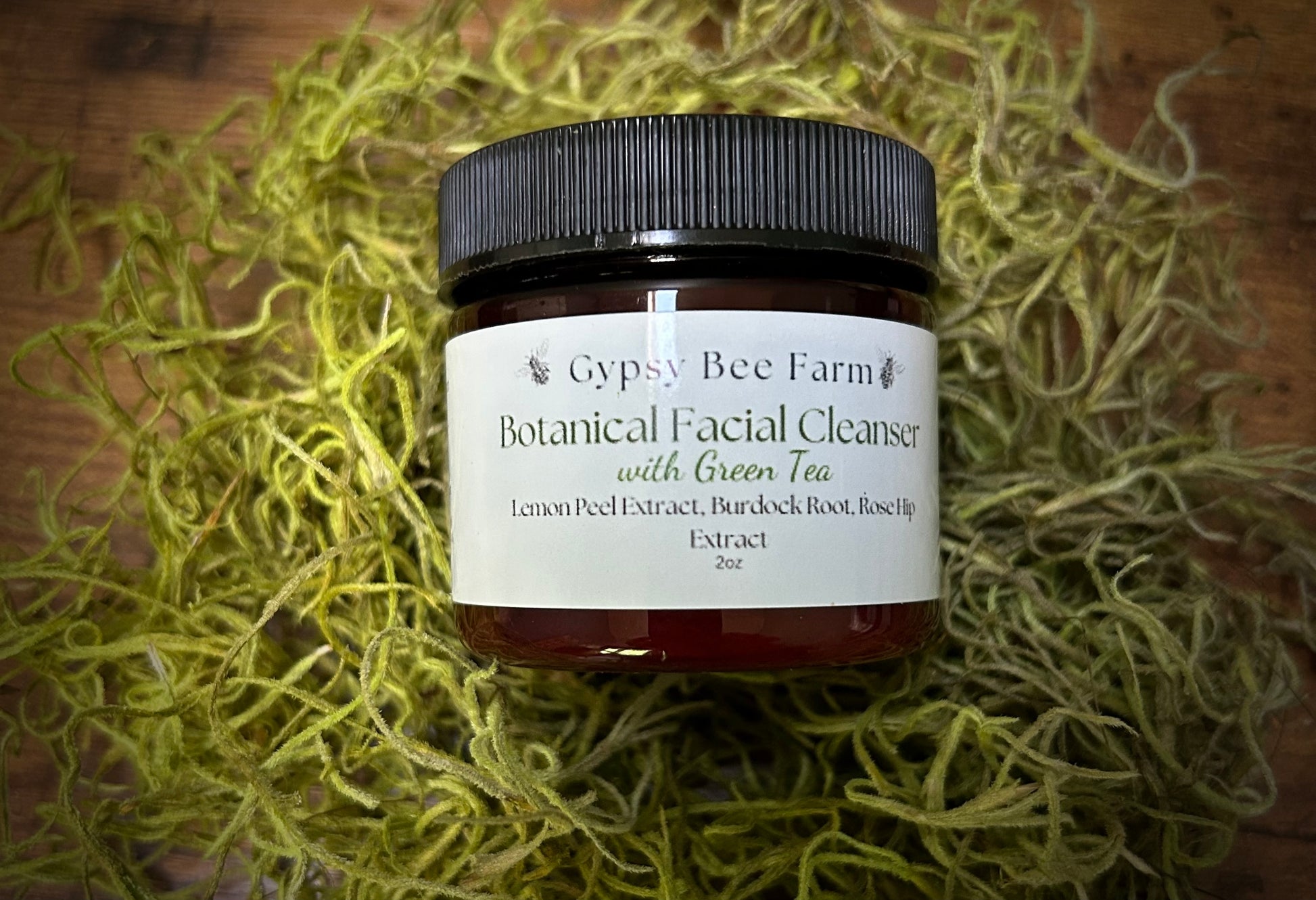 Jar of Gypsy Bee Farm Botanical Facial Cleanser with Green Tea on a textured surface