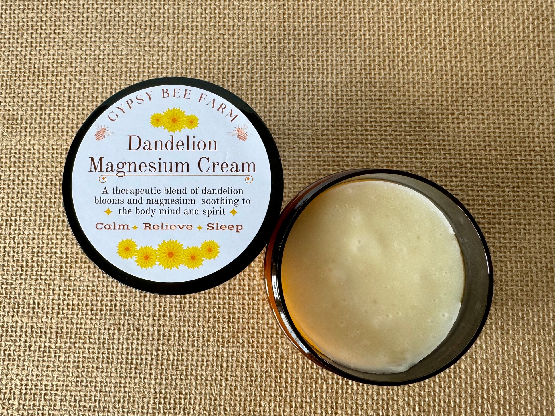 Gypsy Bee Farm Dandelion Magnesium Cream jar on a textured beige background