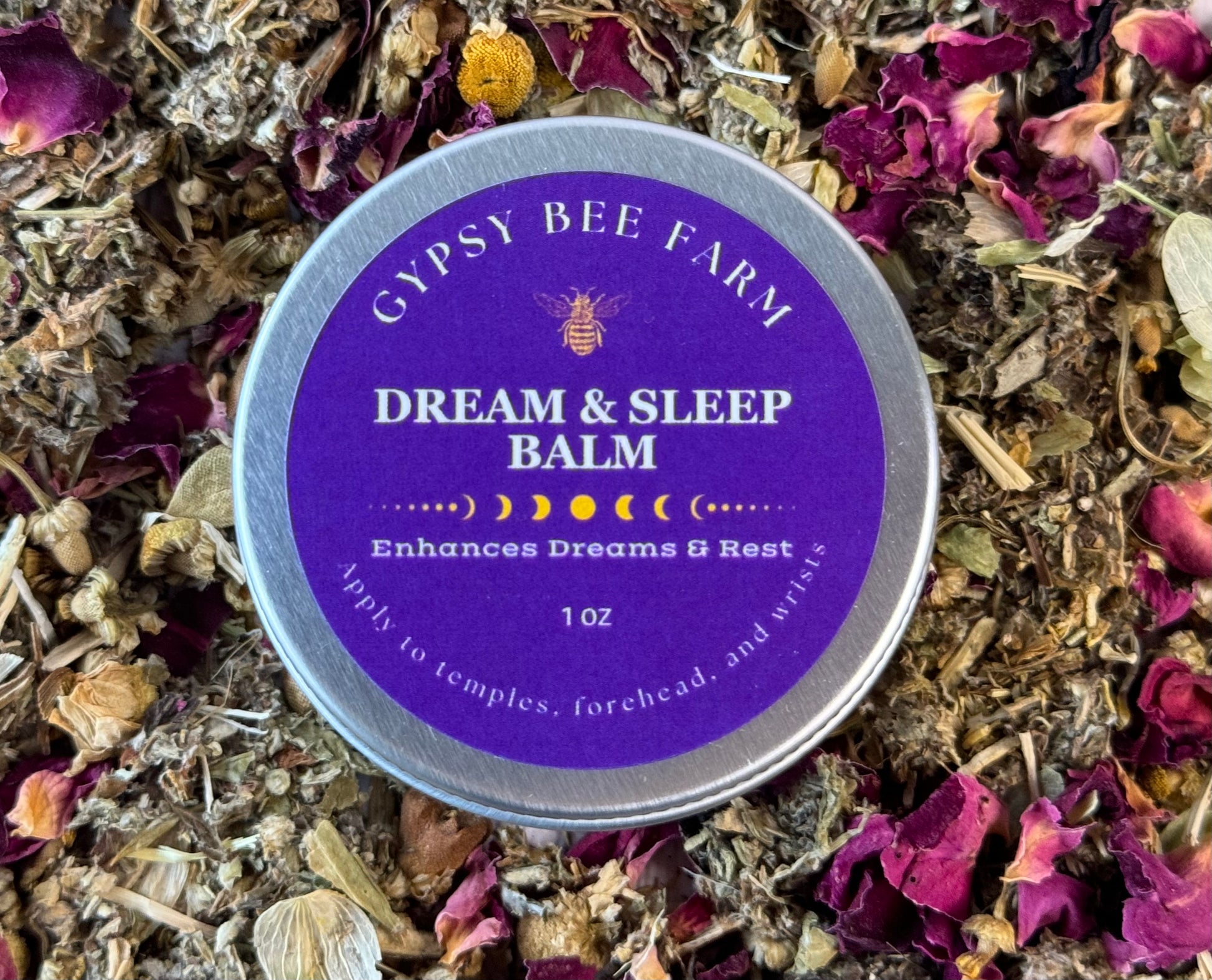 Gypsy Bee Farm Dream & Sleep Balm tin surrounded by dried herbs and flowers